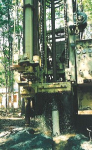 Air rotary drilling after casing has been set